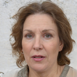 Joyful white adult female with medium  brown hair and blue eyes