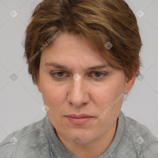 Joyful white adult female with short  brown hair and blue eyes