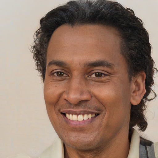 Joyful black adult male with short  brown hair and brown eyes