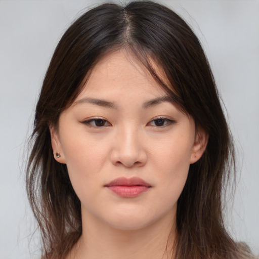 Joyful asian young-adult female with long  brown hair and brown eyes