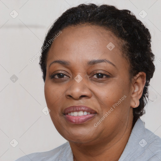 Joyful black adult female with short  brown hair and brown eyes