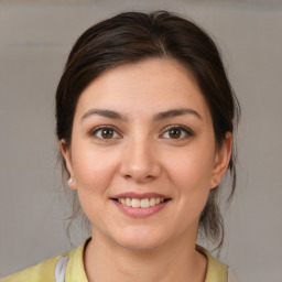 Joyful white young-adult female with medium  brown hair and brown eyes