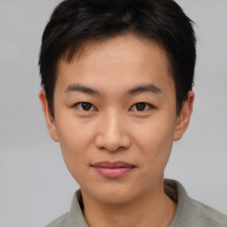 Joyful asian young-adult male with short  brown hair and brown eyes