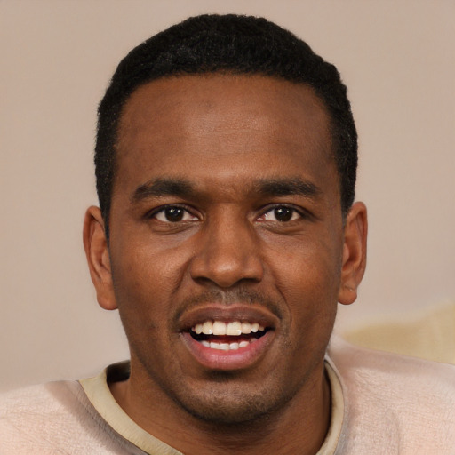 Joyful black young-adult male with short  black hair and brown eyes