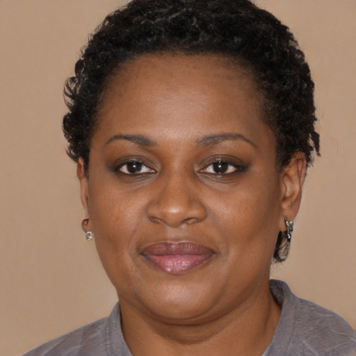 Joyful black adult female with short  brown hair and brown eyes