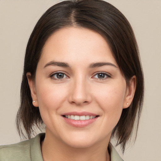 Joyful white young-adult female with medium  brown hair and brown eyes