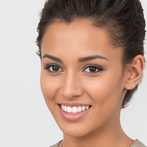 Joyful latino young-adult female with short  brown hair and brown eyes