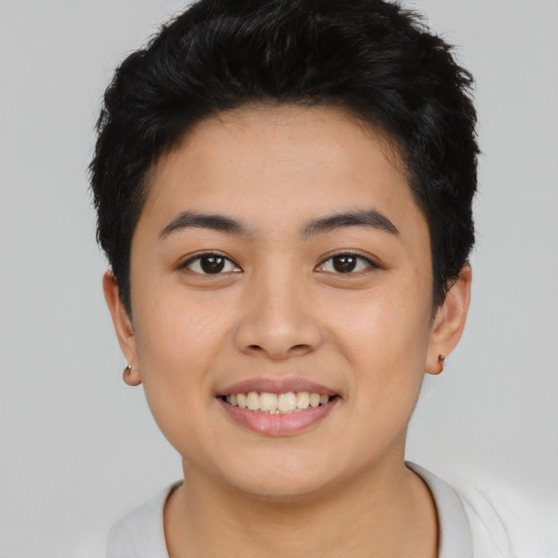Joyful asian young-adult female with short  black hair and brown eyes