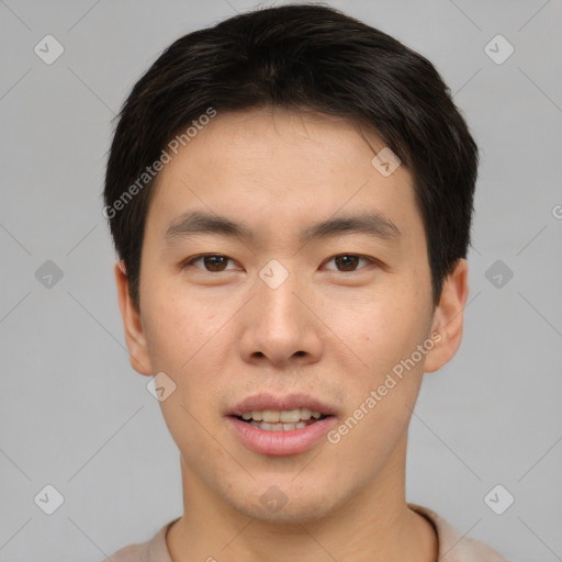 Joyful asian young-adult male with short  brown hair and brown eyes