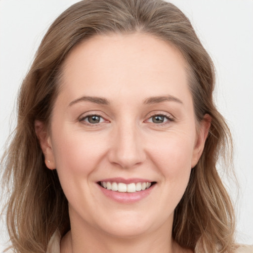 Joyful white young-adult female with long  brown hair and grey eyes