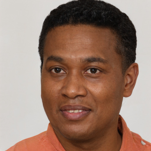Joyful latino young-adult male with short  brown hair and brown eyes