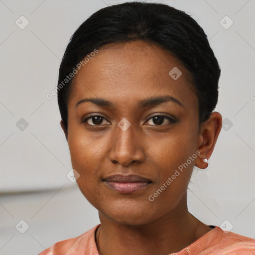 Joyful black young-adult female with short  black hair and brown eyes