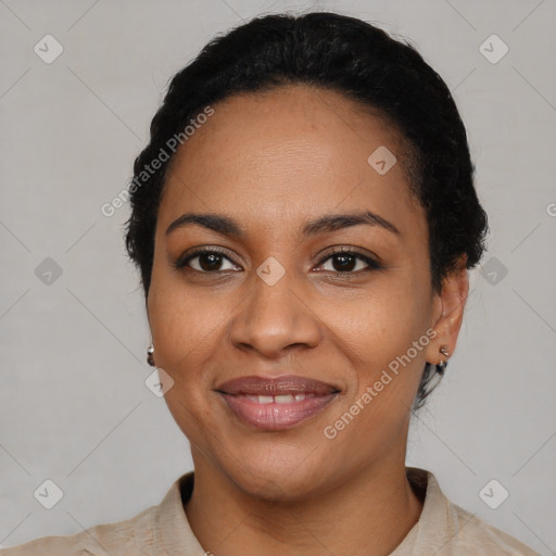 Joyful black young-adult female with short  black hair and brown eyes