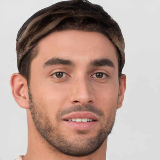 Joyful white young-adult male with short  brown hair and brown eyes