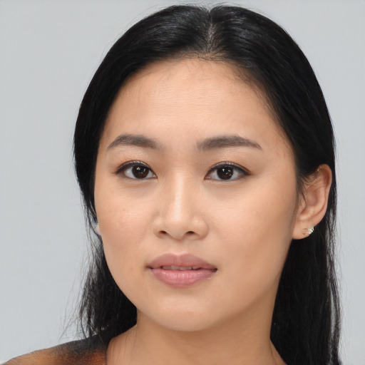 Joyful asian young-adult female with long  black hair and brown eyes