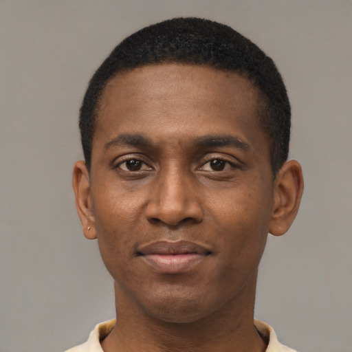 Joyful black young-adult male with short  black hair and brown eyes