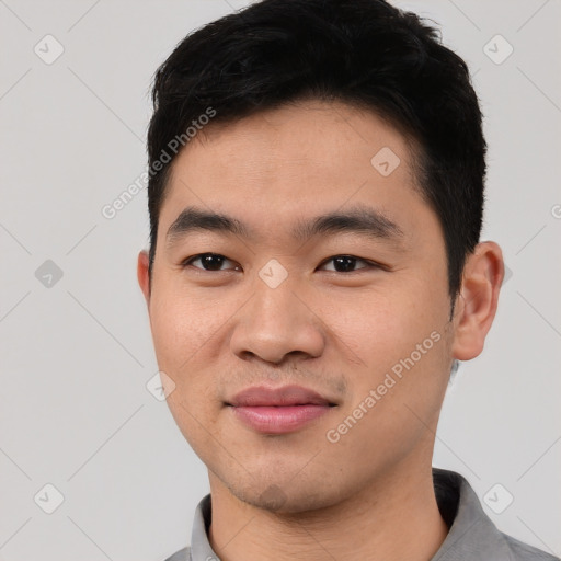 Joyful asian young-adult male with short  black hair and brown eyes