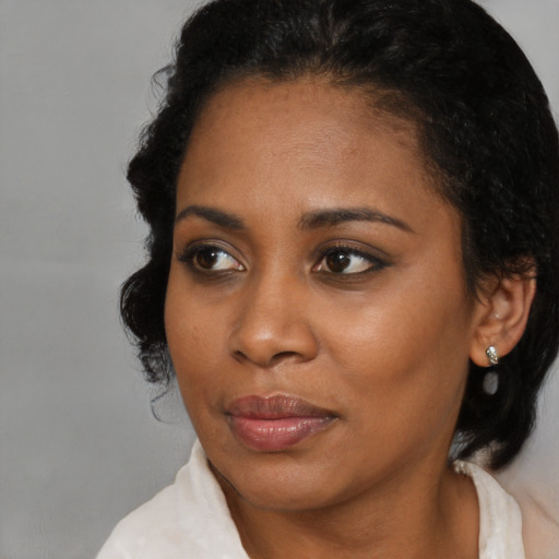 Joyful black young-adult female with medium  brown hair and brown eyes