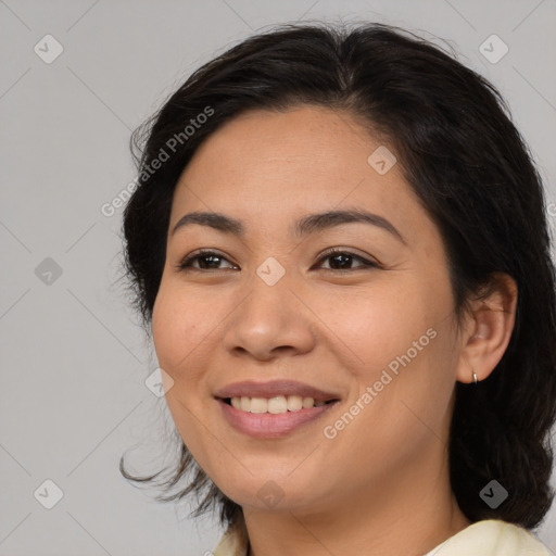 Joyful latino young-adult female with medium  brown hair and brown eyes