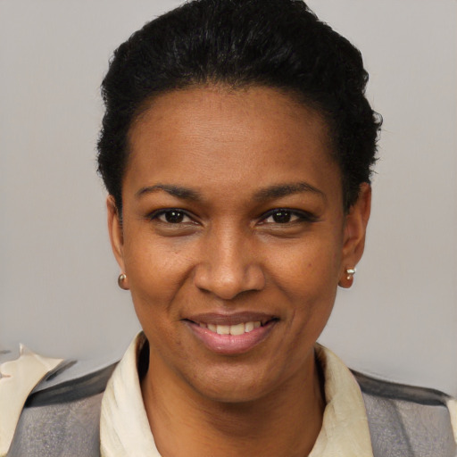 Joyful black young-adult female with short  black hair and brown eyes