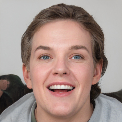 Joyful white young-adult female with medium  brown hair and blue eyes