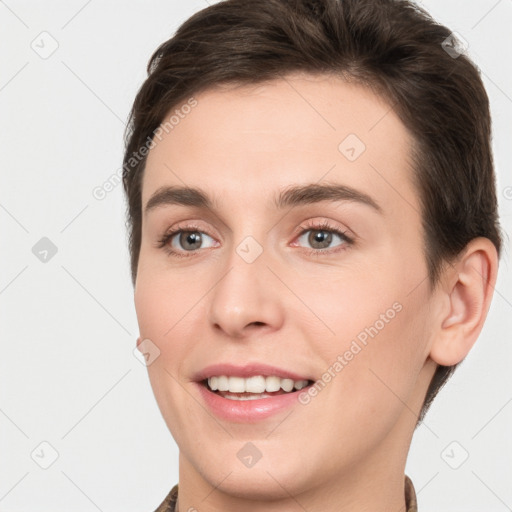 Joyful white young-adult female with short  brown hair and brown eyes