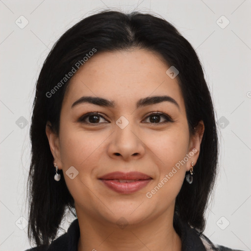 Joyful latino young-adult female with long  black hair and brown eyes