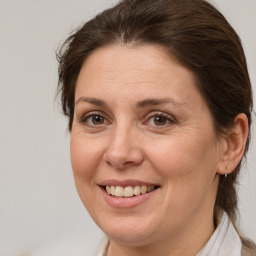 Joyful white adult female with medium  brown hair and brown eyes