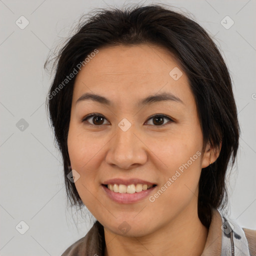 Joyful latino young-adult female with medium  brown hair and brown eyes