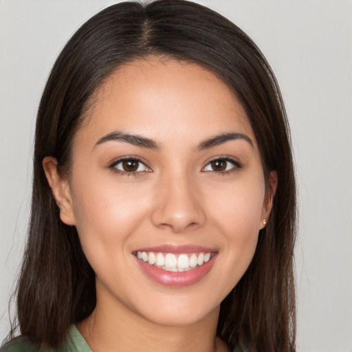 Joyful white young-adult female with long  brown hair and brown eyes