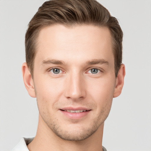 Joyful white young-adult male with short  brown hair and grey eyes