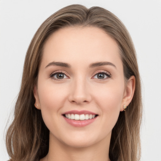 Joyful white young-adult female with long  brown hair and brown eyes