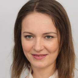 Joyful white young-adult female with medium  brown hair and brown eyes