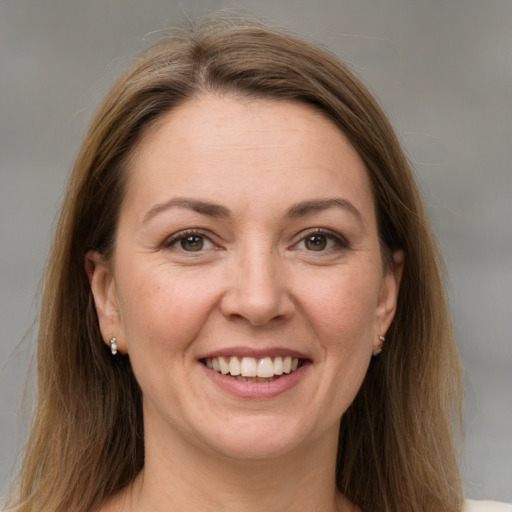 Joyful white adult female with long  brown hair and grey eyes