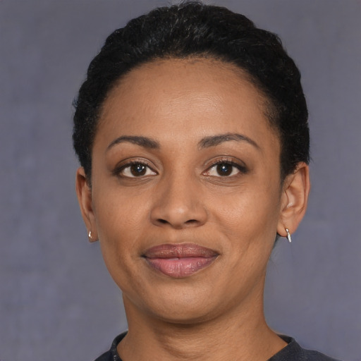 Joyful latino young-adult female with short  black hair and brown eyes