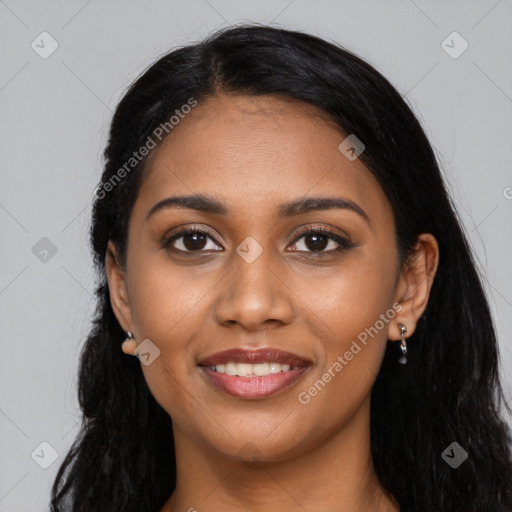 Joyful black young-adult female with long  black hair and brown eyes