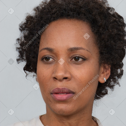 Joyful black adult female with short  brown hair and brown eyes