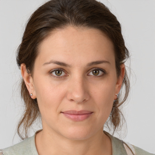 Joyful white young-adult female with medium  brown hair and brown eyes