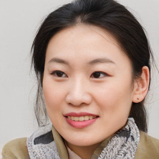 Joyful asian young-adult female with medium  brown hair and brown eyes