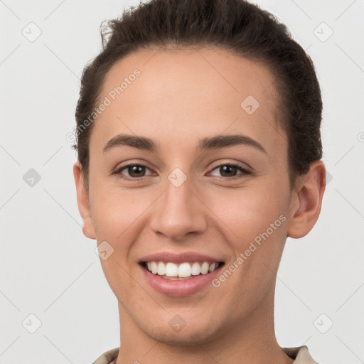 Joyful white young-adult female with short  brown hair and brown eyes