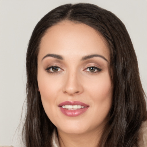 Joyful white young-adult female with long  brown hair and brown eyes