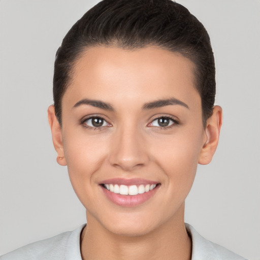 Joyful white young-adult female with short  brown hair and brown eyes