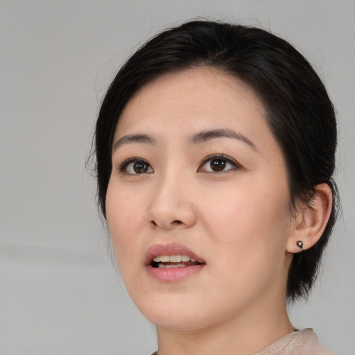 Joyful asian young-adult female with medium  black hair and brown eyes