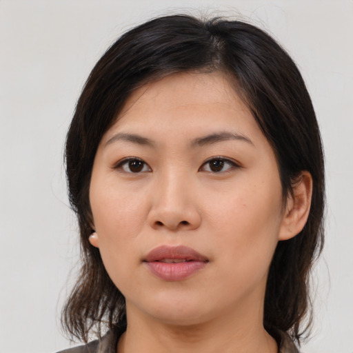 Joyful asian young-adult female with medium  brown hair and brown eyes