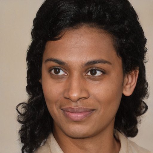 Joyful black young-adult female with medium  brown hair and brown eyes