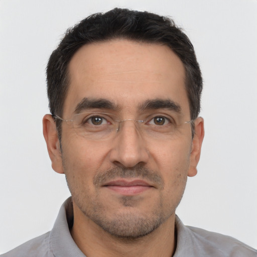 Joyful white adult male with short  black hair and brown eyes