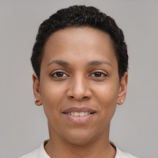 Joyful latino young-adult female with short  black hair and brown eyes