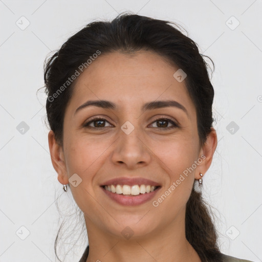 Joyful latino young-adult female with long  brown hair and brown eyes