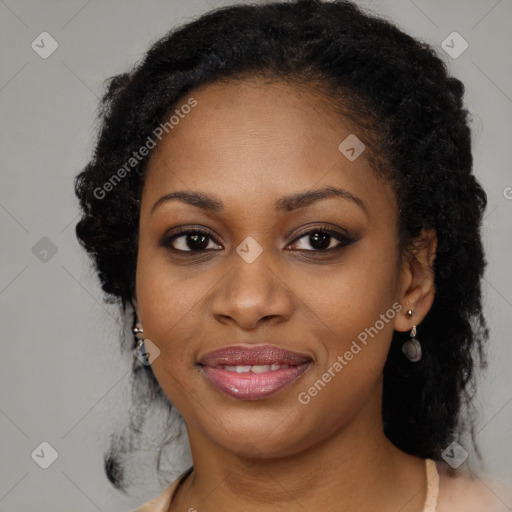 Joyful black young-adult female with long  brown hair and brown eyes