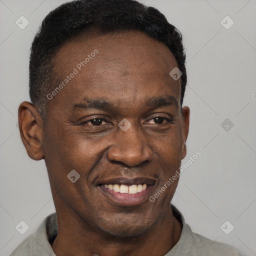 Joyful black adult male with short  black hair and brown eyes